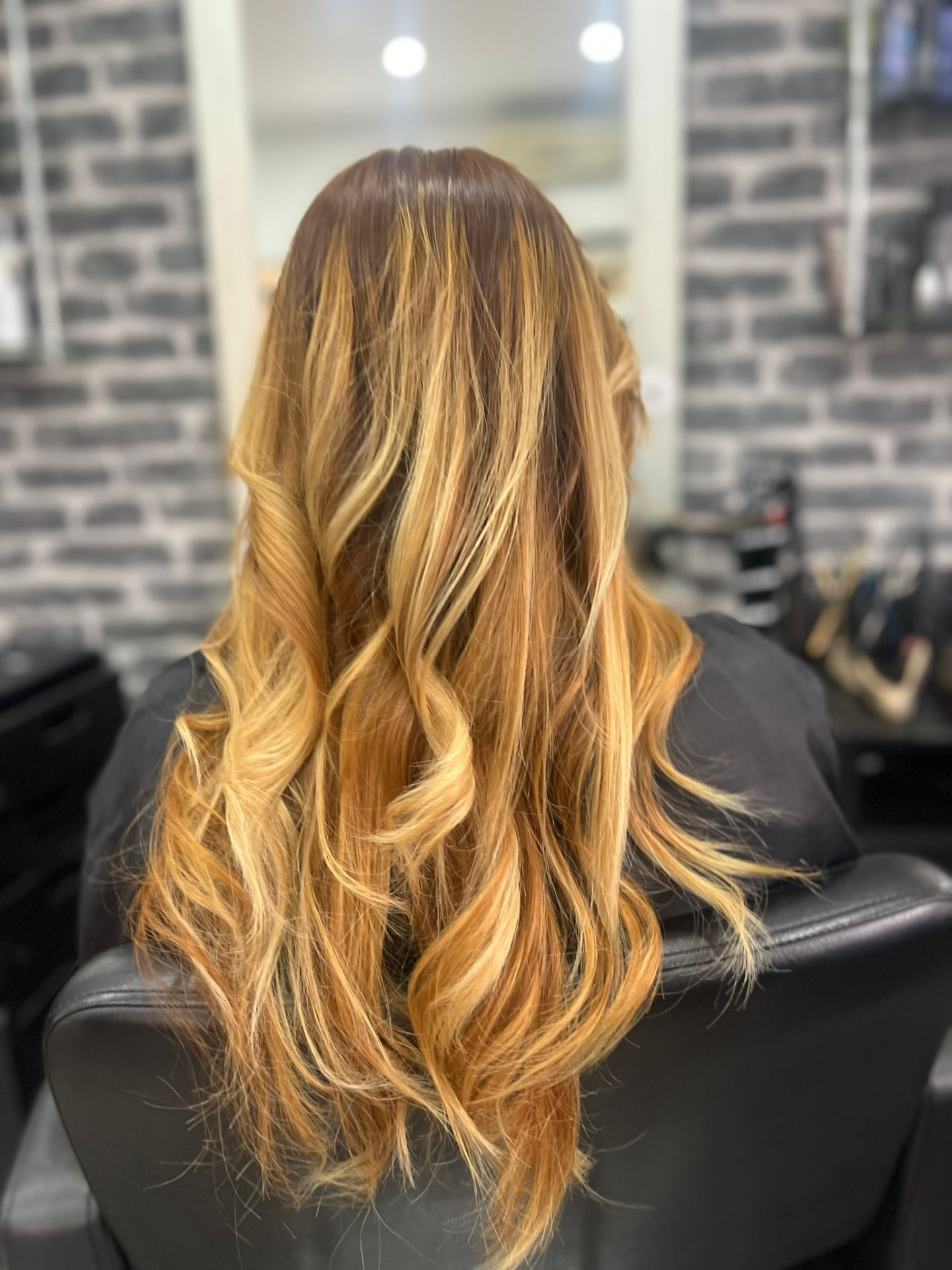 Golden foil highlights with a bouncy blow wave finish